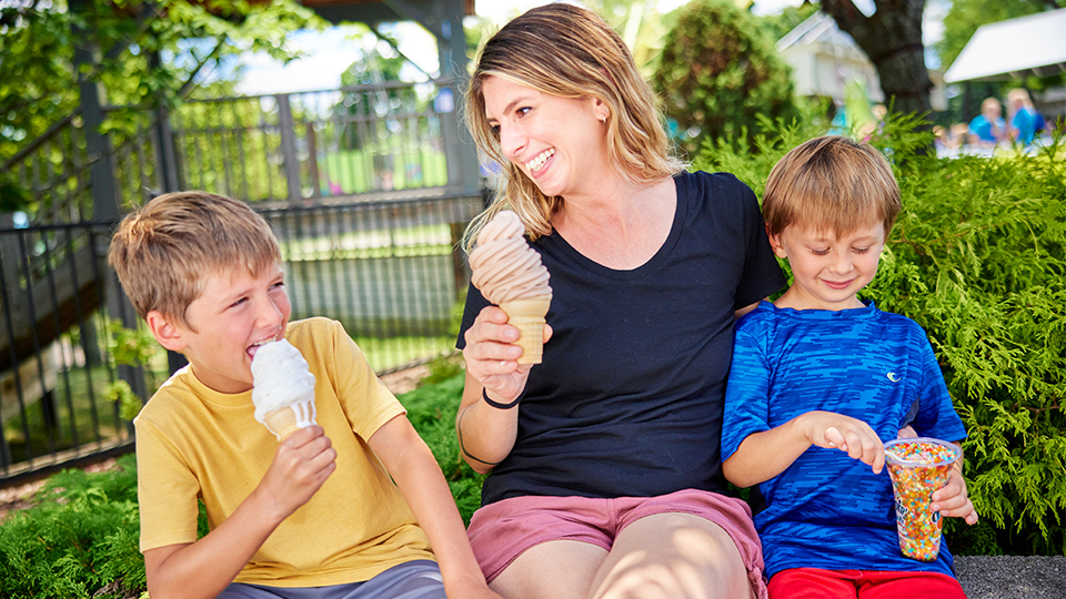 Mom eating ice cream with boys