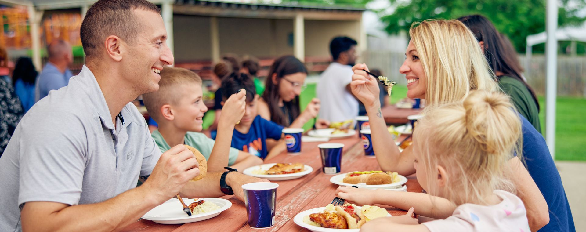 A family enjoys lunch in the group event groves.